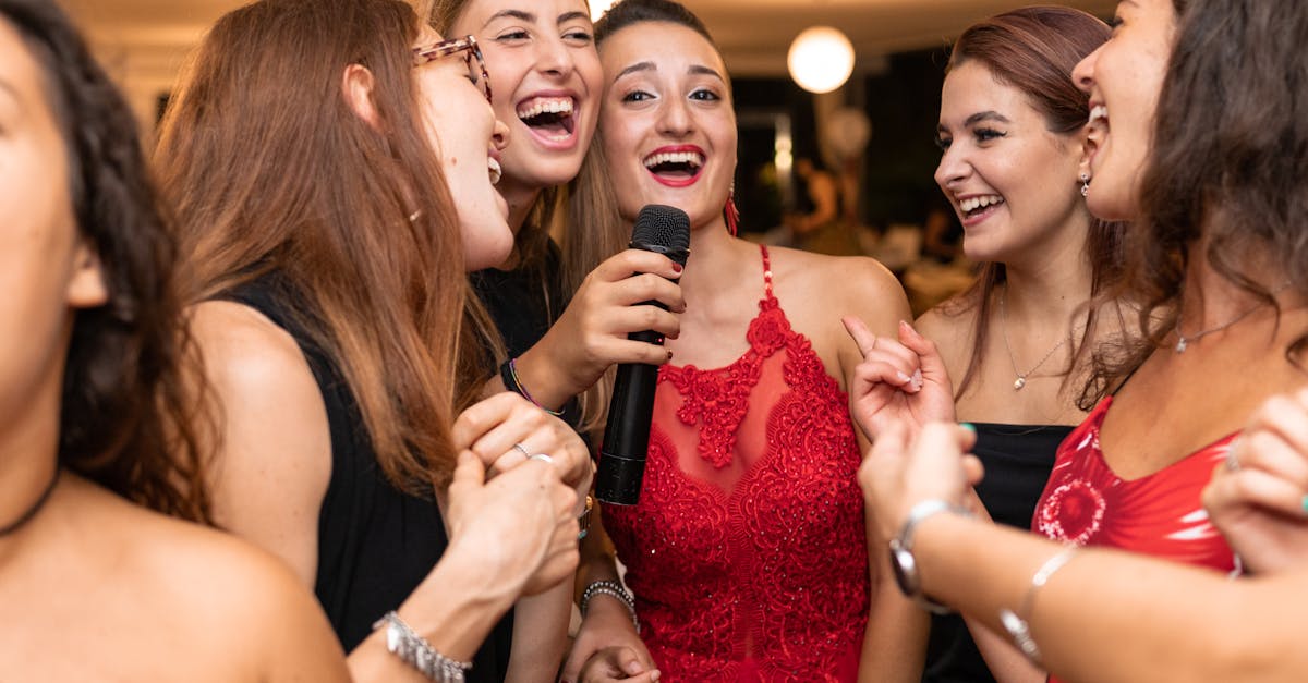 Joyful group of women singing and celebrating indoors, capturing a lively and festive atmosphere.